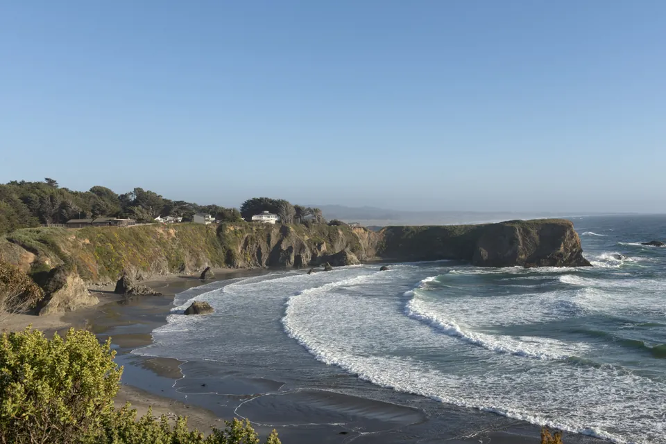 Waves curving into a cove on the Northern California coast