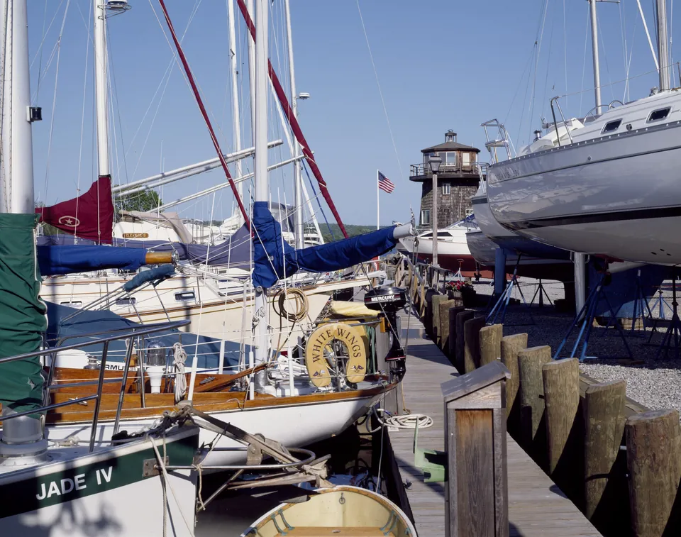 Sailboats moored along a dock at a marina in Essex, Connecticut