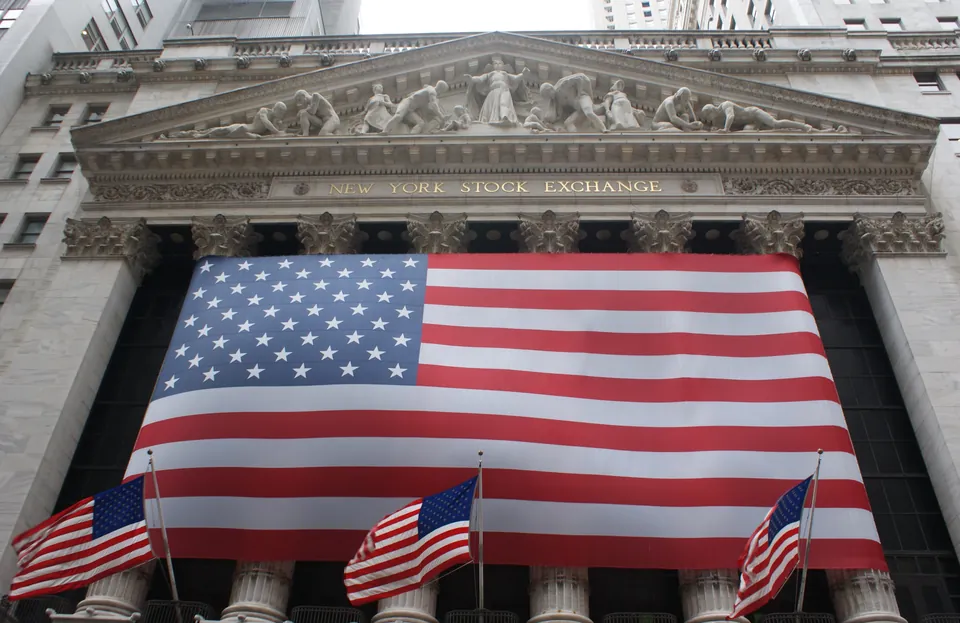 New York Stock Exchange facade with a large U.S. flag