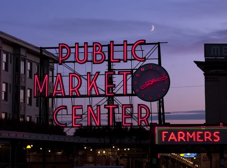 Public Market Center neon sign at dusk in Seattle