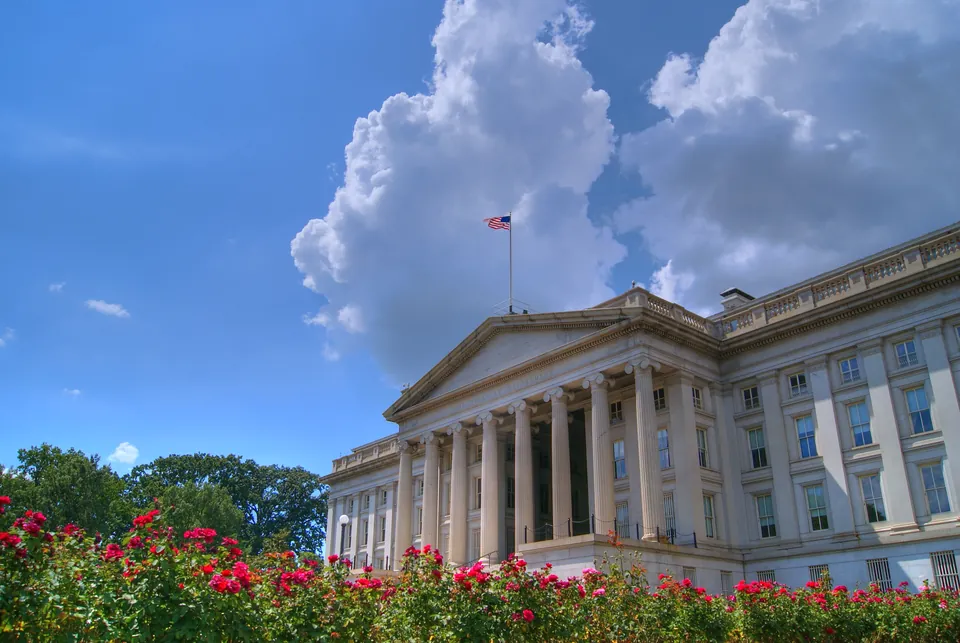 U.S. Treasury Building in daylight under a blue sky